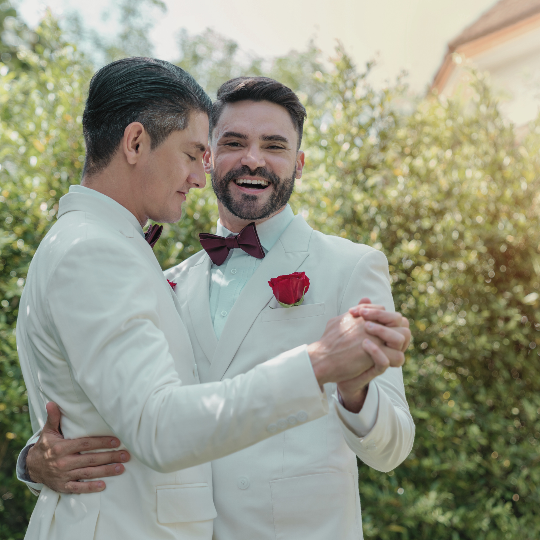 Two men dancing together at their wedding